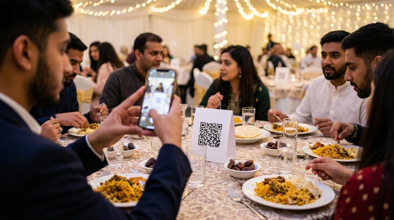 Guest at a charity dinner scanning a QR code on the table with their phone, fairy lights in the background